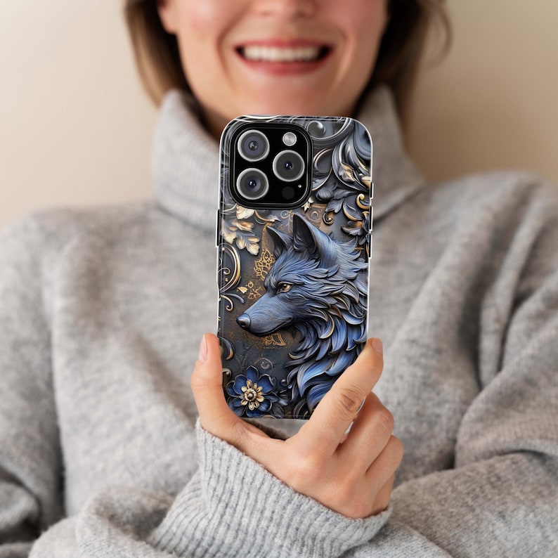 May include: A blue and gold phone case with a wolf design. The wolf is in a detailed, almost 3D style, with gold accents. The case has a floral pattern in the background.