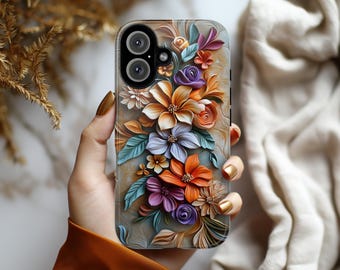 Può includere: Una custodia per telefono con un design floreale. La custodia presenta una varietà di fiori in tonalità di arancione, rosa, viola e blu. I fiori sono disposti in un motivo a bouquet e sono circondati da foglie verdi. La custodia è realizzata in un materiale trasparente, che consente di vedere il telefono attraverso il design.