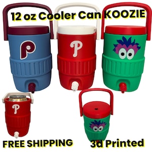May include: Five 12 oz cooler can koozies with handles and spigots. Three are large, two are small. Colors include blue, red, and green. Designs feature a maroon P logo, a white P logo, and a purple and blue monster face with white eyes.