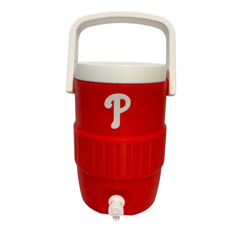 May include: A bright red beverage cooler featuring a white lid and a white carrying handle. The front of the cooler displays a white letter P logo. A small white spigot is located at the bottom center of the cylindrical container for dispensing.