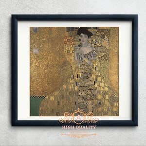 Puede incluir: Impresión enmarcada de una pintura de Gustav Klimt, que presenta a una mujer con un vestido y un fondo dorados ornamentados. La obra de arte está en un marco negro con un passe-partout blanco. El texto "HIGH QUALITY VINTAGE ART" está en la parte inferior.
