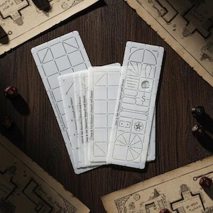 May include: A selection of white stencils featuring geometric and architectural patterns, such as squares, triangles, and arches. The stencils are displayed on a dark wooden surface, with dice and map fragments nearby. The text "Iren & Mrs. Derenson, Stencil and Stamp" is present.