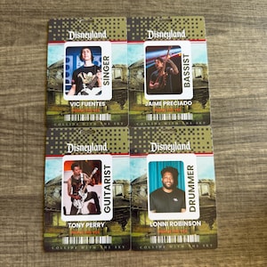 May include: Four rectangular Disneyland backstage passes featuring the band Pierce the Veil. Each pass displays a band member, their role, and the album title Collide with the Sky. The members are Vic Fuentes, Jaime Preciado, Tony Perry, and Lonni Robinson.