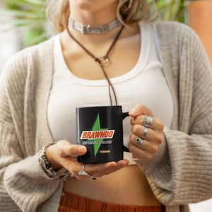 May include: Black ceramic mug with a white lightning bolt and the text "Brawndo The Thirst Mutilator" in red and green.