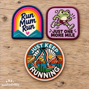 May include: Three embroidered patches featuring running themes. One arch-shaped patch says Run Mum Run with a rainbow and mountains. One square patch shows a green frog running with the text Just One More Mile. One circular patch shows legs running with the text Just Keep Running.