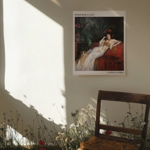May include: A framed print of a painting titled "Persephone (c.1443)" - Goddess of Spring. The painting depicts a woman in a white gown with a dog sitting beside her. The woman is wearing a crown of flowers and a necklace. The painting is set against a dark background with lush greenery.
