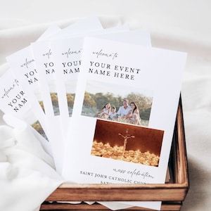 May include: A stack of white paper programs for a mass celebration at Saint John Catholic Church. The programs feature a photo of a family and a photo of a cross with candles.