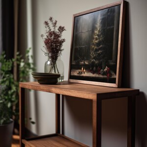 May include: A dark wood shelf with a framed painting of a Christmas tree in a window. The painting is on the top shelf and there are two small plates on the bottom shelf.