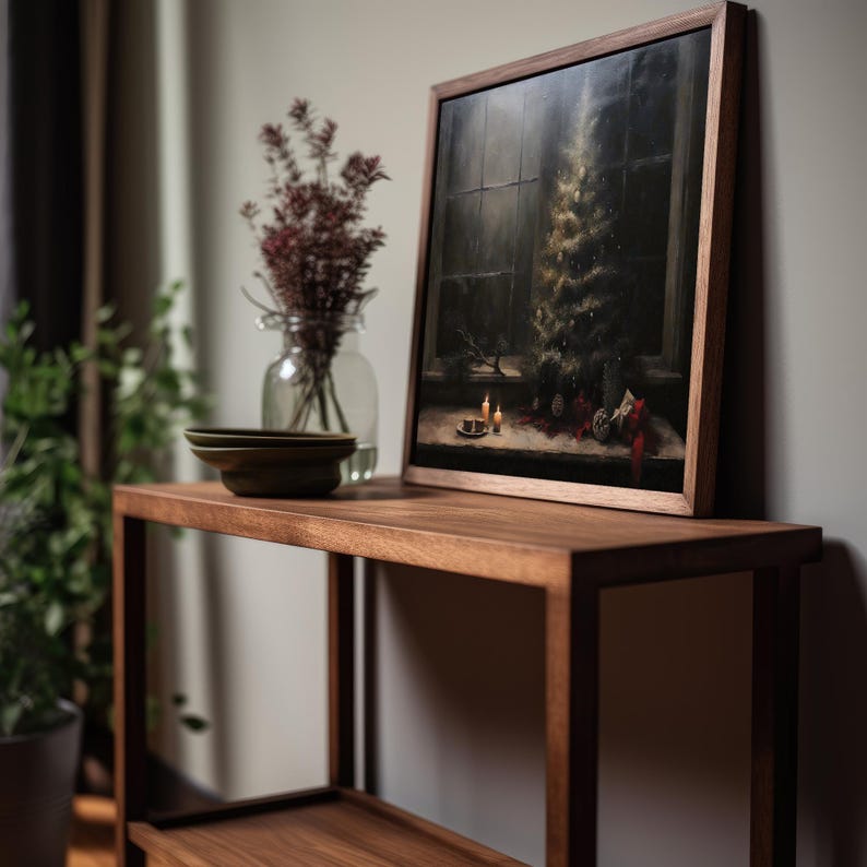 May include: A dark wood shelf with a framed painting of a Christmas tree in a window. The painting is on the top shelf and there are two small plates on the bottom shelf.