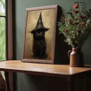 May include: A framed painting of a black cat wearing a witch's hat. The cat has bright yellow eyes and is sitting on a brown background.