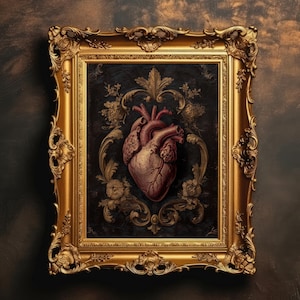 May include: A framed artwork featuring a detailed anatomical heart illustration. The heart is rendered in shades of red and brown, set against a dark background with ornate gold floral accents. The frame is a heavily ornamented gold color.