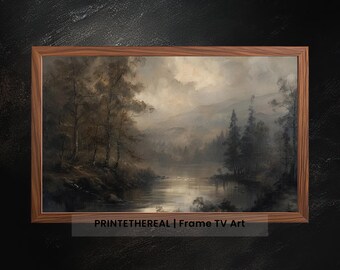 Op de afbeelding: Een ingelijst landschapsschilderij toont een serene meerlandschap met bomen en bergen onder een bewolkte hemel. Het kunstwerk is in gedempte tinten grijs, bruin en beige, met de tekst "PRINTETHEREAL | Frame TV Art" onderaan.