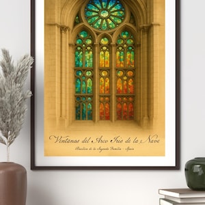 May include: Framed print of a stained-glass window from the Sagrada Familia in Spain. The window features a vibrant array of colors, including blue, green, yellow, orange, and red. The text "Ventanas del Arco Iris de la Nave" is visible.