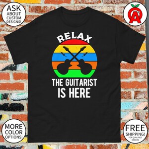 Relax The Guitarist Is Here T-Shirt - Adult Unisex - Gifts for Birthdays Rock n' Roll Fans Musicians Guitar Enthusiasts Music Lovers