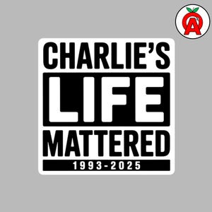 May include: A white sticker with black text that reads "CHARLIE'S LIFE MATTERED 1993-2025". The sticker has a black border and is on a grey background. A small logo with a red apple and the letter "A" is in the upper right corner.