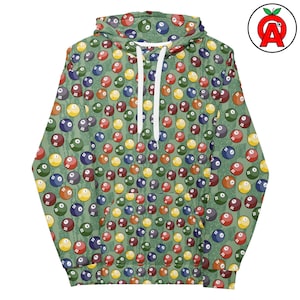 Puede incluir: Una sudadera con capucha verde con un patrón repetido de bolas de billar coloridas. Las bolas son de varios colores, incluyendo rojo, amarillo, azul y verde, sobre un fondo verde texturizado. La sudadera tiene un cordón blanco y una capucha.