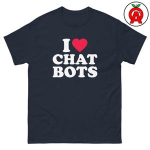May include: Navy blue t-shirt with the text "I ♥ CHAT BOTS" in white, with a red heart replacing the word "love". The shirt has a classic crew neck and short sleeves. A logo is in the upper right corner.