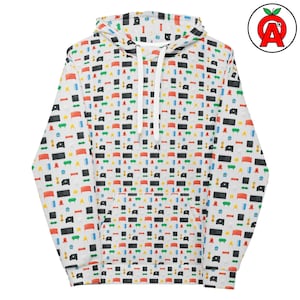 Könnte beinhalten: Weißer Kapuzenpullover mit einem sich wiederholenden Muster aus bunten abstrakten Formen. Das Design umfasst rote, blaue, grüne und schwarze Elemente. Der Hoodie hat einen Kordelzug und eine Vordertasche.