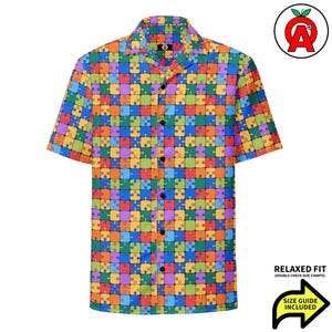 Könnte beinhalten: Kurzärmeliges Button-Down-Hemd mit einem farbenfrohen Puzzlespiel-Muster. Das Hemd hat eine entspannte Passform und eine Größentabelle ist enthalten. Das Hemd hat einen klassischen Kragen und schwarze Knöpfe.