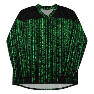 May include: Black and green long-sleeved jersey with a V-neck. The jersey features a digital rain pattern in green, with a black panel across the shoulders and upper chest. The design resembles falling code.