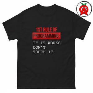 May include: A black short-sleeved t-shirt featuring the red and white text 1ST RULE OF PROGRAMMING: IF IT WORKS DON'T TOUCH IT. The text is centred on the chest, with the first line enclosed in a red rectangular border. A small logo is in the corner.
