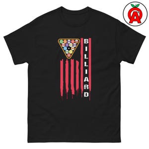 May include: Black t-shirt featuring a graphic design related to billiards. The design includes a triangle of billiard balls, red vertical stripes, and the word "BILLIARD" in white capital letters. The shirt has a classic crew neck.