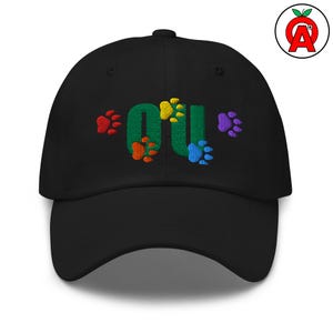 May include: Black baseball cap with embroidered "OU" in green, with colorful paw prints. The paw prints are red, orange, yellow, blue, and purple. A logo of a red apple with a white "A" is on the right side.