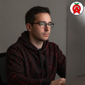 A man in his 30s wearing the hoodie during a coding session showing off Binary Code AOP Hoodie, Computer Programming Unisex Top, Matrix Code Graphic Pullover, Hacker Soft Sweater