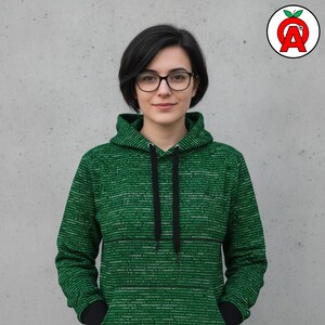 A female coding student in her 20s with minimalist tech-inspired styling showing off Computer Programming AOP Hoodie, Code Pattern Unisex Top, Software Developer Graphic Pullover, Binary Logic Soft Sweater