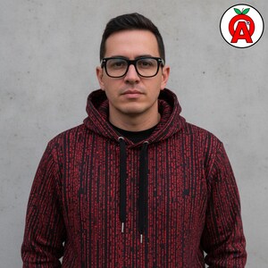 A man in his 30s wearing thick-rimmed glasses showing off Matrix Binary AOP Hoodie, Computer Programming Unisex Top, Software Engineer Graphic Pullover, Digital Code Soft Sweater