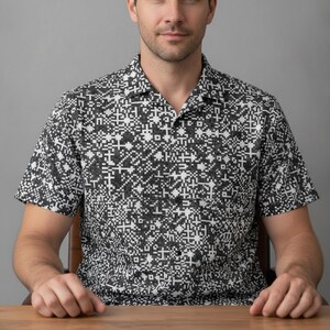 A man in his 30s wearing the tech shirt at a desk showing off Digital Binary Hawaiian Shirt, Tech Matrix Aloha Shirt, QR Code Button Down, Barcode Camp Shirt, Pixel Pattern Beach Top