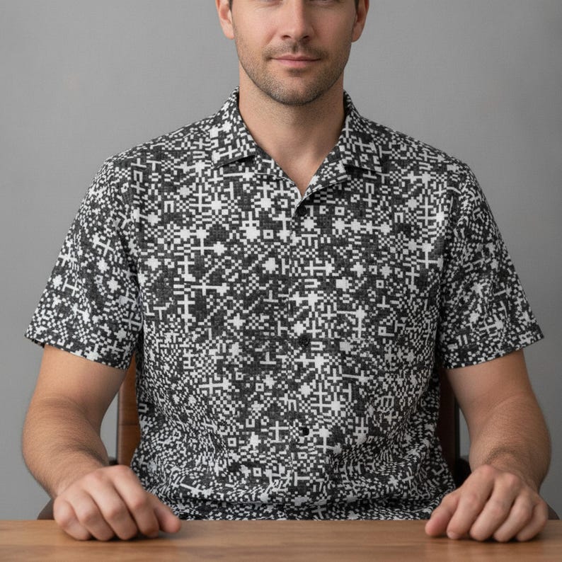 A man in his 30s wearing the tech shirt at a desk showing off Digital Binary Hawaiian Shirt, Tech Matrix Aloha Shirt, QR Code Button Down, Barcode Camp Shirt, Pixel Pattern Beach Top