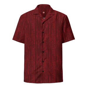 May include: A short-sleeved button-down shirt in a deep red hue, featuring a vertical pattern of red lines and symbols. The shirt has a classic collar and black buttons. This casual shirt is suitable for everyday wear.