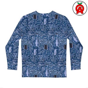 May include: A long-sleeved shirt with a blue circuit board pattern. The design features white and light blue lines and squares, resembling electronic components. The shirt has a crew neck and is made of a soft material.