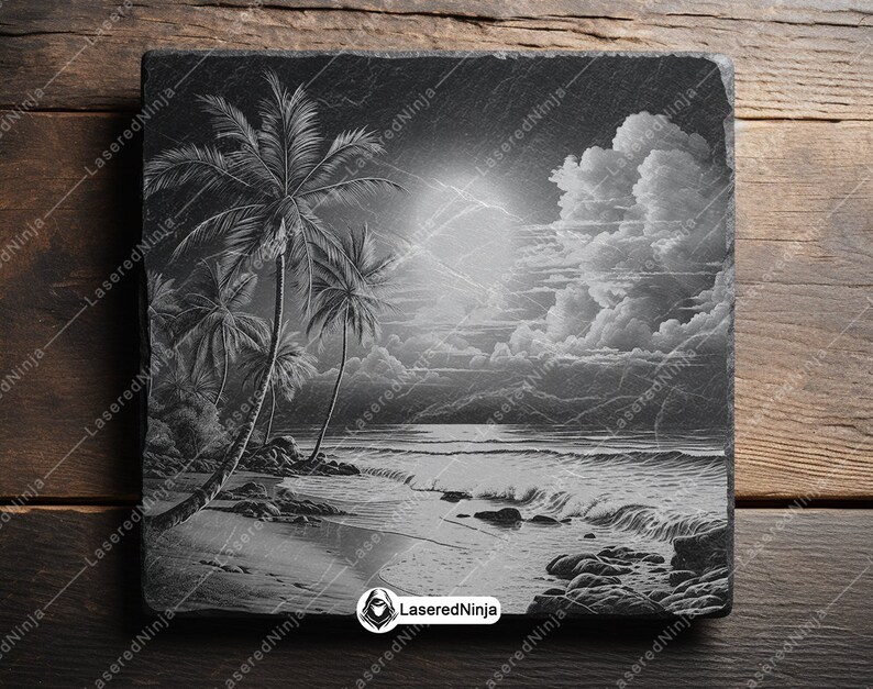 May include: A black and white engraved slate coaster featuring a palm tree and beach scene. The scene includes a palm tree, ocean waves, and a cloudy sky.