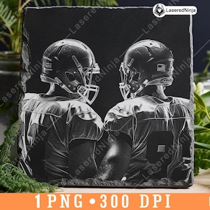 May include: Black and white image of two football players wearing helmets and jerseys. The image is engraved on a black slate background.