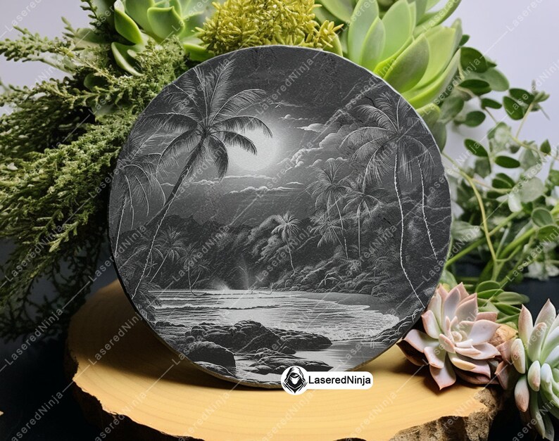 May include: A black slate coaster with a laser-etched design of a tropical beach scene with palm trees, a moon, and waves. The coaster has the text "LaseredNinja" in white lettering.