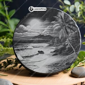 May include: A black slate coaster with a detailed engraving of a tropical beach scene. The engraving depicts palm trees, a sandy beach, ocean waves, and a mountain range in the distance.