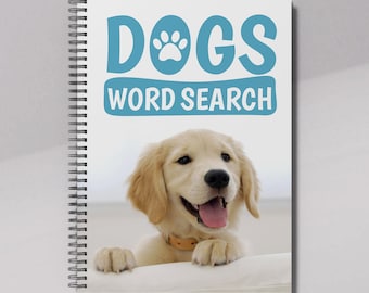 Może przedstawiać: Szyty spiralnie notes z białą okładką, na której widnieje niebieska łapka i napis "DOGS WORD SEARCH". Złoty retriever szczeniak zagląda zza okładki.