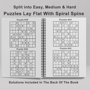 May include: A book with a spiral spine containing four Sudoku puzzles. The puzzles are labeled as Puzzle #39, Puzzle #40, Puzzle #41, and Puzzle #42. The book states that solutions are included in the back of the book.