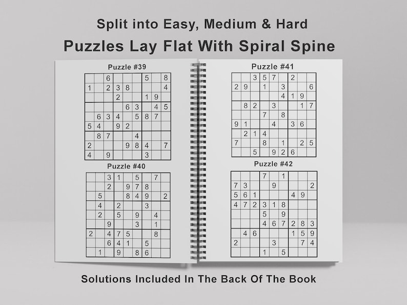May include: A book with a spiral spine containing four Sudoku puzzles. The puzzles are labeled as Puzzle #39, Puzzle #40, Puzzle #41, and Puzzle #42. The book states that solutions are included in the back of the book.
