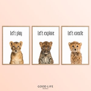May include: Three framed prints with images of baby animals and text. The first print features a lion cub with the text "Let's play". The second print features a leopard cub with the text "Let's explore". The third print features a cheetah cub with the text "Let's create".
