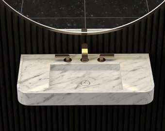 May include: A white rectangular bathroom sink with a rounded edge, mounted on a black wall with vertical grooves. The sink has a single faucet with two handles and a round drain.