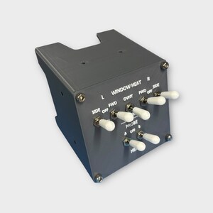 May include: A gray panel with a set of toggle switches labeled "WINDOW HEAT" and "PROBE". The switches have white handles and are labeled with "L", "FWD", "OVHT", "FWD", "SIDE", "A", "OFF", and "B".