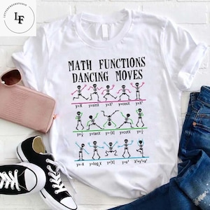 May include: White t-shirt with a graphic of skeletons dancing and the text "MATH FUNCTIONS DANCING MOVES". The skeletons are holding signs with different math functions, such as y=x, y=sinX, y=x³, y=cosX, y=x², y=1/x, y=tanX, y=-|x|, y=cotX, y=1/x, y=-x, y=logx, y=|x|, y=ax, x²+y²=a².