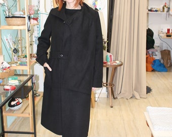 a women's black coat for winter. Warm and long. One size (small- medium). Very uinique collar (scarf style) with pockets.