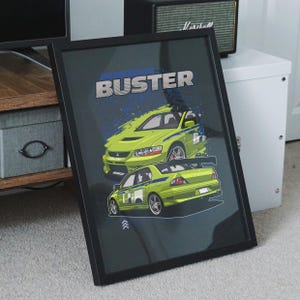 May include: Framed print featuring two lime green sports cars with blue accents. The print has the text "THE BUSTER" in white and blue. The cars are set against a dark gray background.