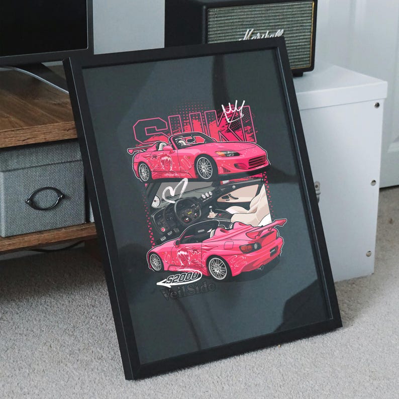 May include: Framed art print featuring a pink sports car design. The artwork includes the text "S2000 VeilSide" and other Japanese text. The image is set against a dark background and framed in black.