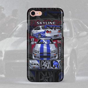 May include: A black iPhone case with a white and blue illustration of a Nissan Skyline GT-R. The case features the Japanese text "SKYLINE" and "GT-R" in red and white. The case also features a close-up of the car's wheels and headlights.