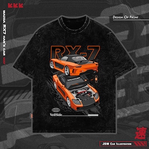 May include: Black t-shirt featuring an orange Mazda RX-7 illustration. The design includes the text "RX-7" and "VeilSide." The graphic shows the car from the front and back. Additional text includes "JDM Car Illustration" and "Design of Front."